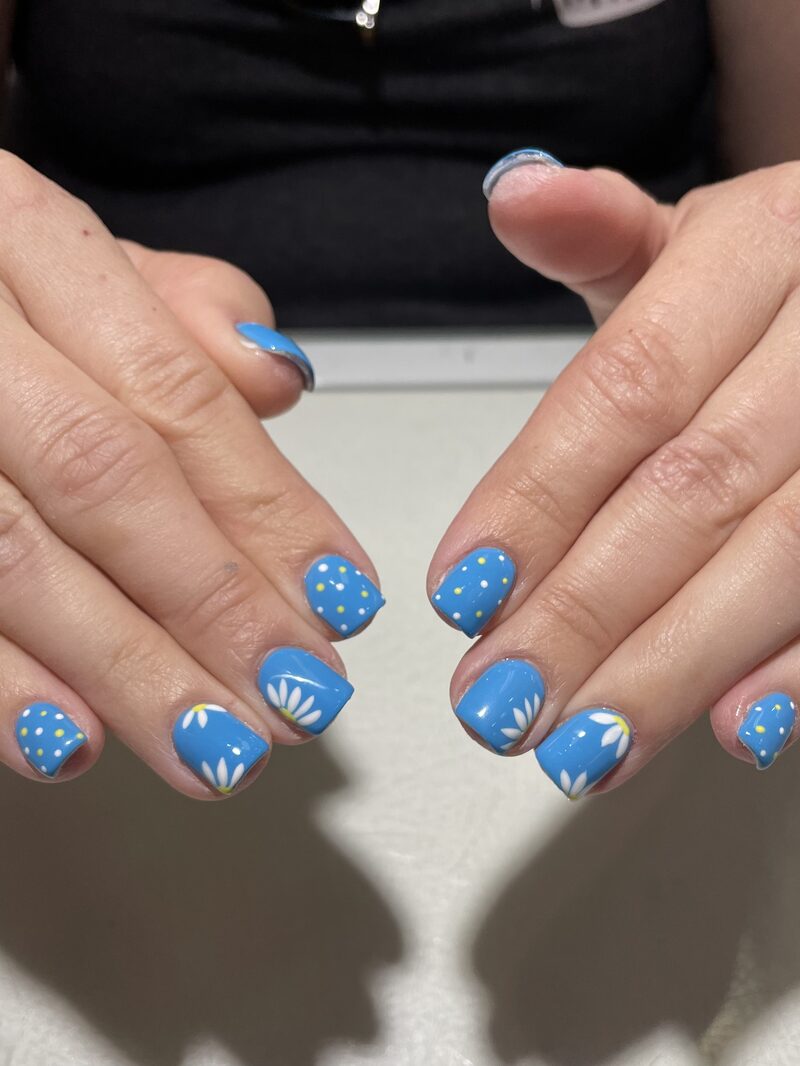 Sky blue gel nails with white daisy and polka dot art