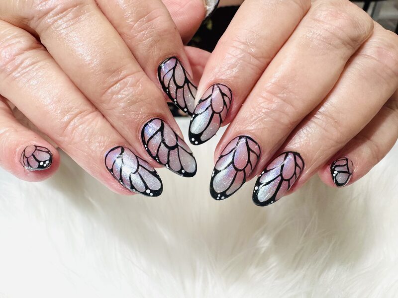 Pink and black butterfly wing nail art on almond shape