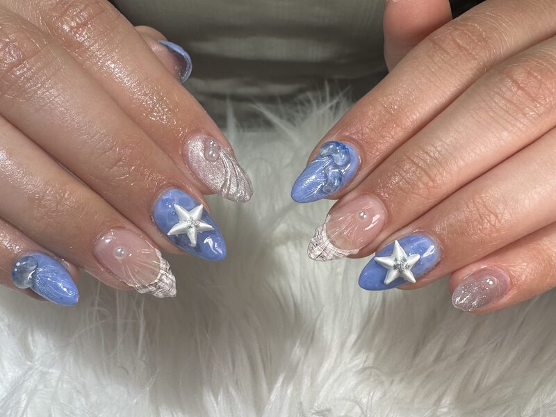 Sky blue ocean nails with 3D starfish and seashell charms