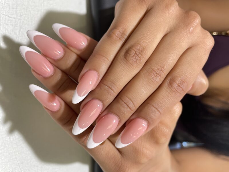 Nude almond nails with thin classic white french tips